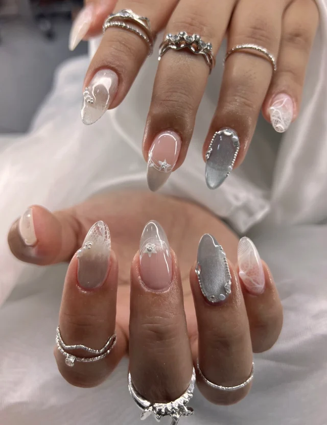 Soft nude tones, silver shine, and delicate lace details 🤍🕊️ 
Book now at: https://gemmanailsspa.ca

#DreamyNails #SoftGlamNails #SilverChrome #LaceNailArt